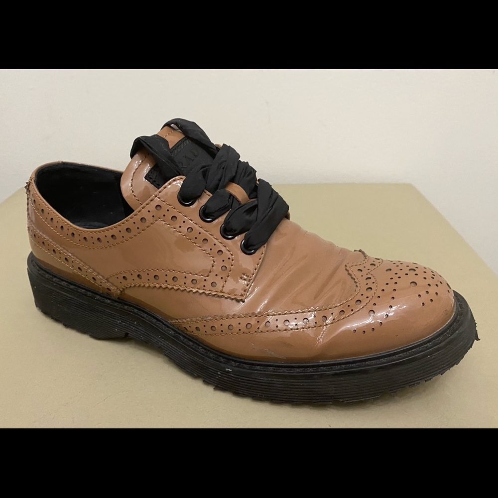 PRADA Patent leather wing tip brogue shoes.